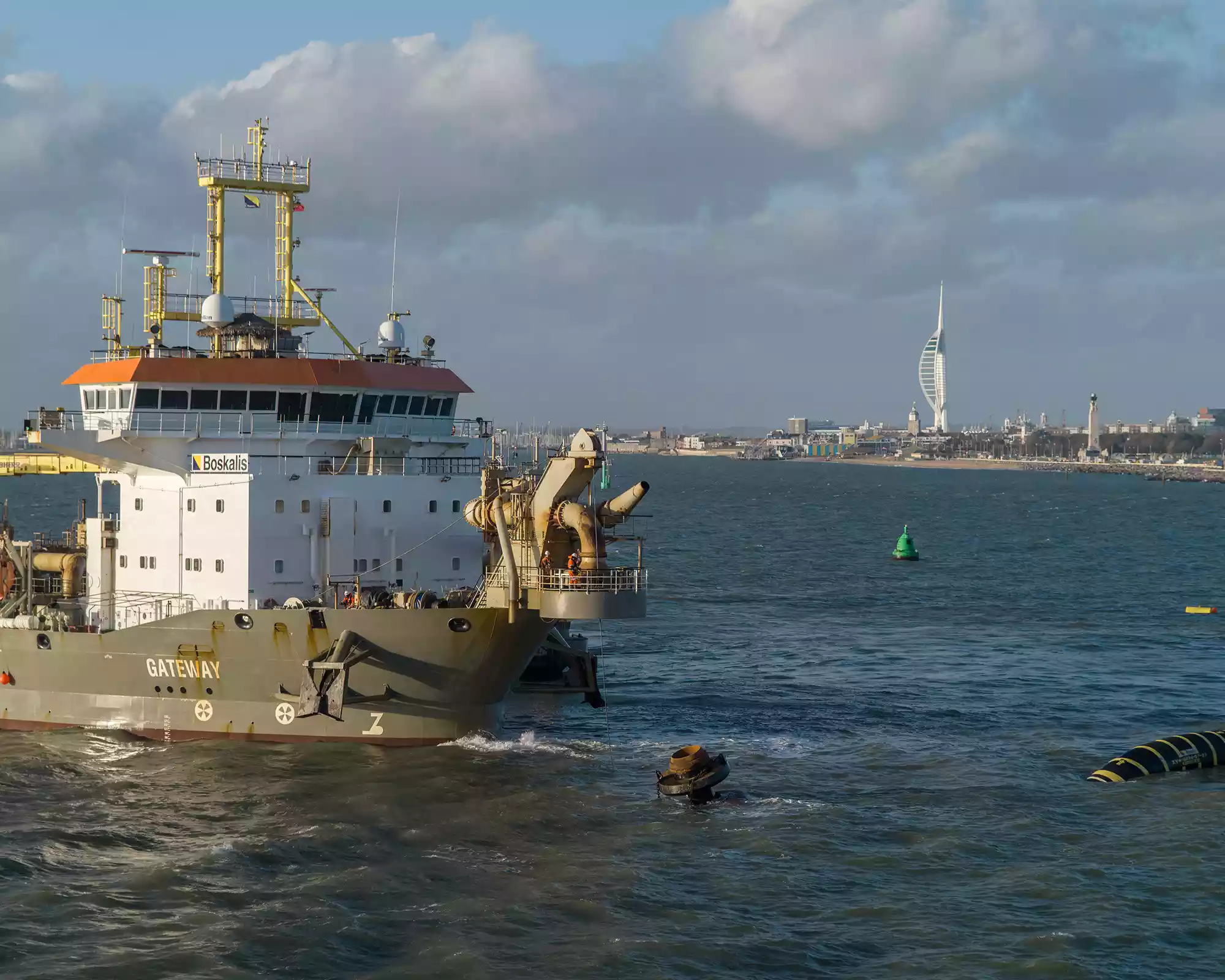 Boskalis Gateway dredger working in Portsmouth Harbour, with the Spinnaker Tower in the background